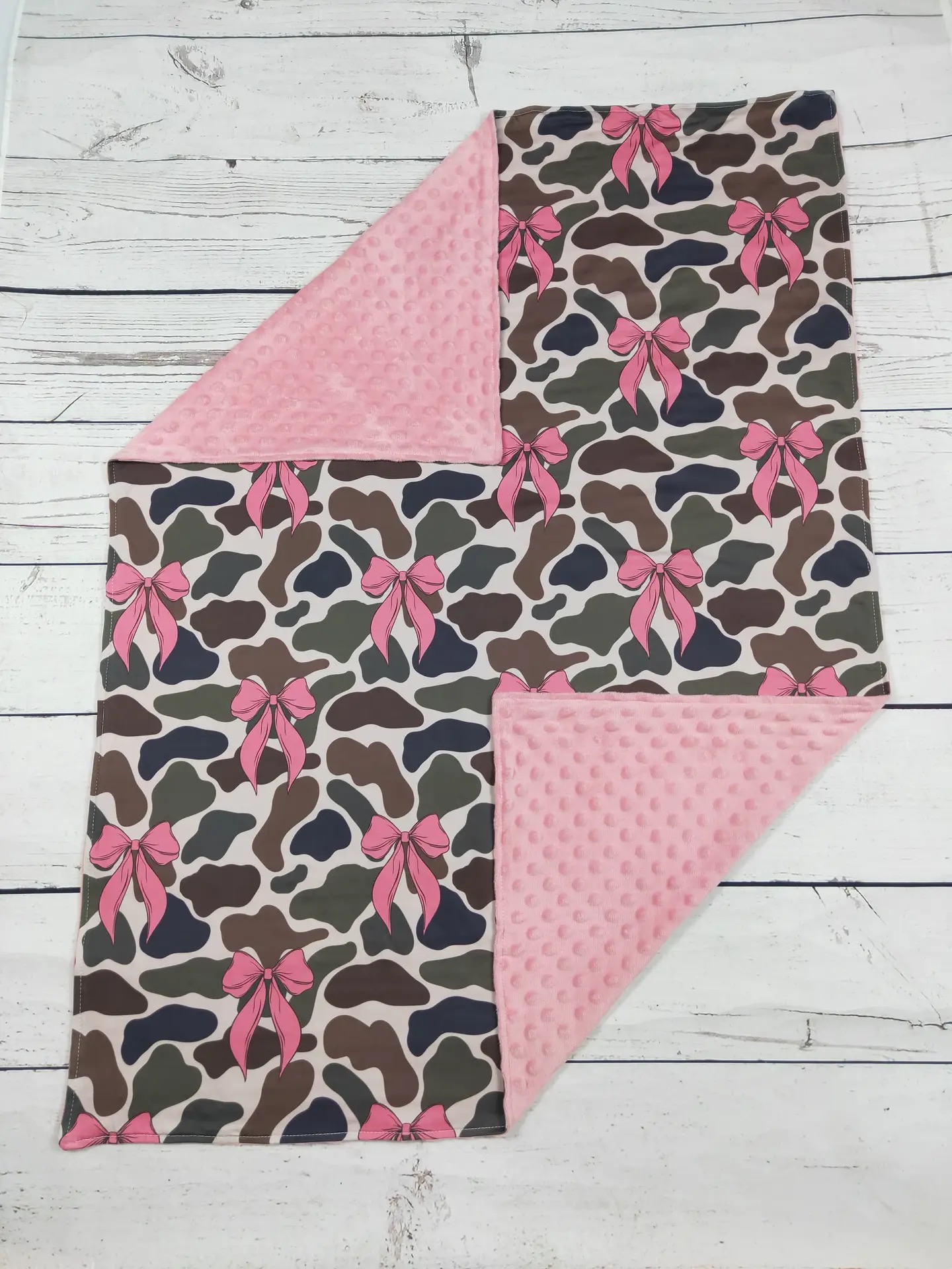 Camo print baby blanket with pink bows and pink minky dot backing