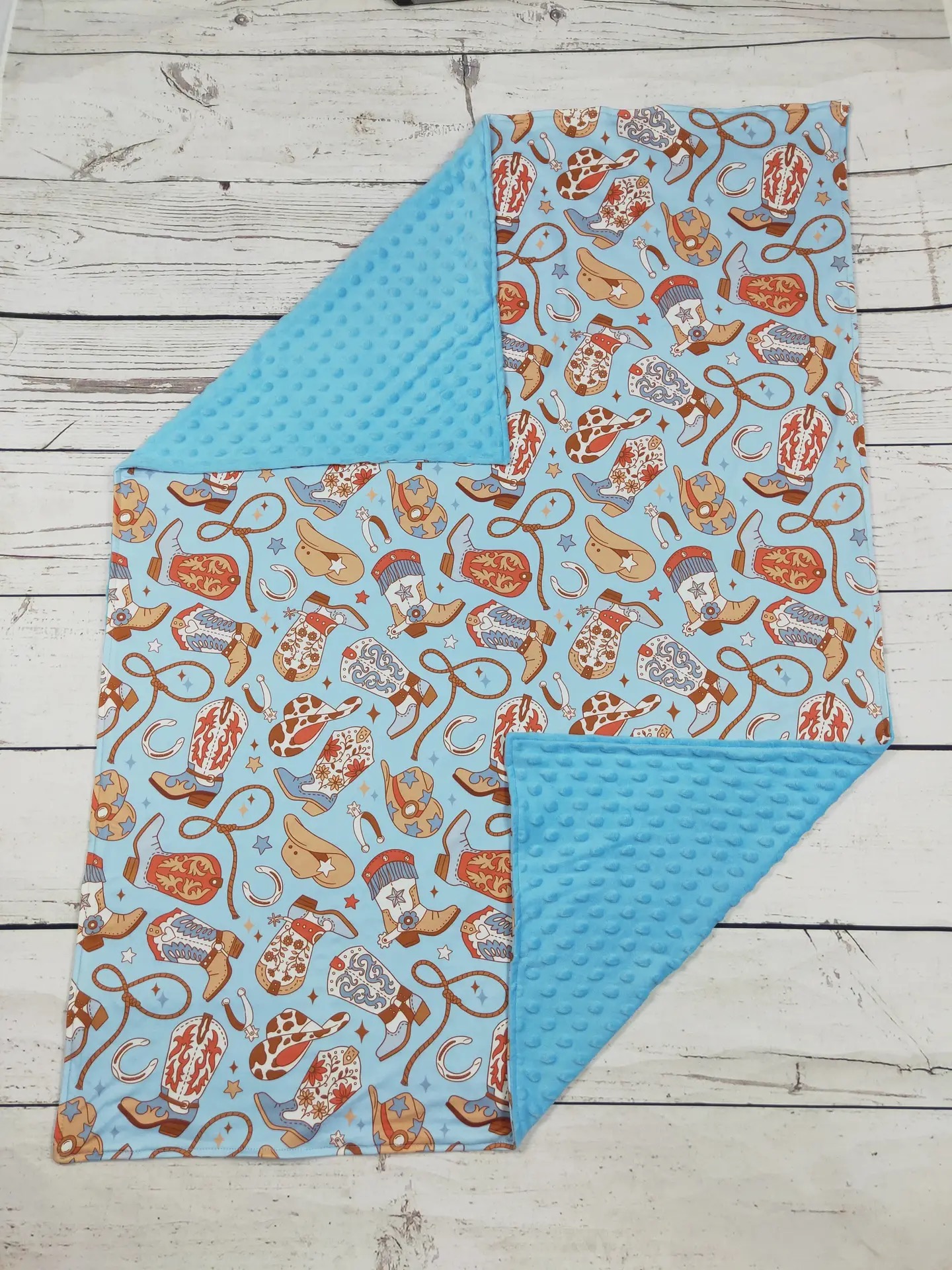 Blue cowboy boots and hats print baby blanket with turquoise minky dot backing