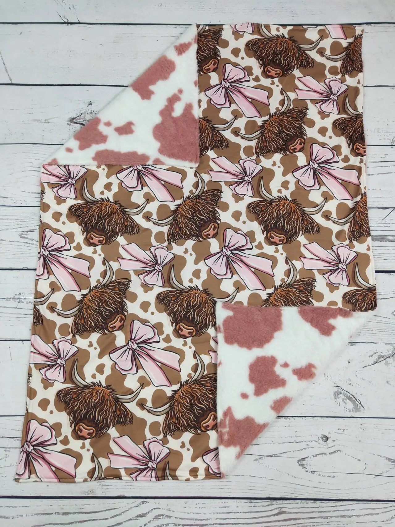 Highland cow and pink bow print baby blanket with pink cow print minky backing