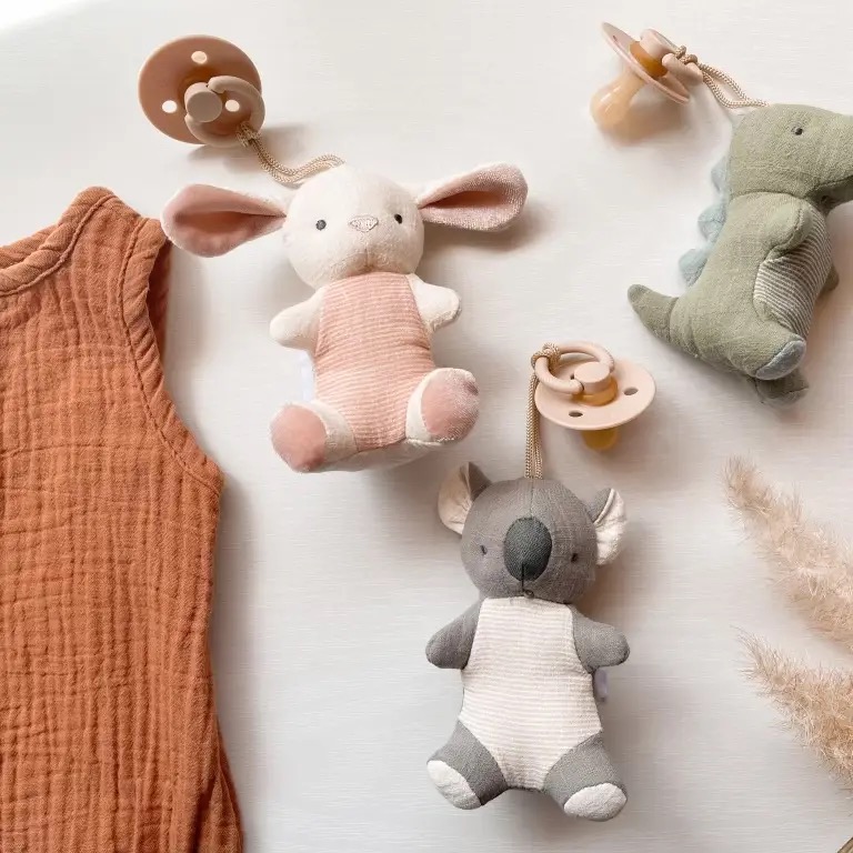 Itzy Ritzy pacifier pals collection with bunny, koala, and dinosaur plush attachments