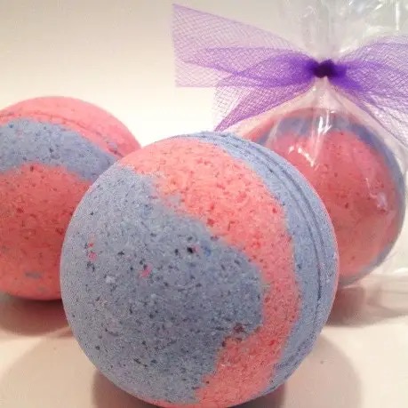 Pink and blue swirled cotton candy moisturizing bath bombs with purple tulle wrapping