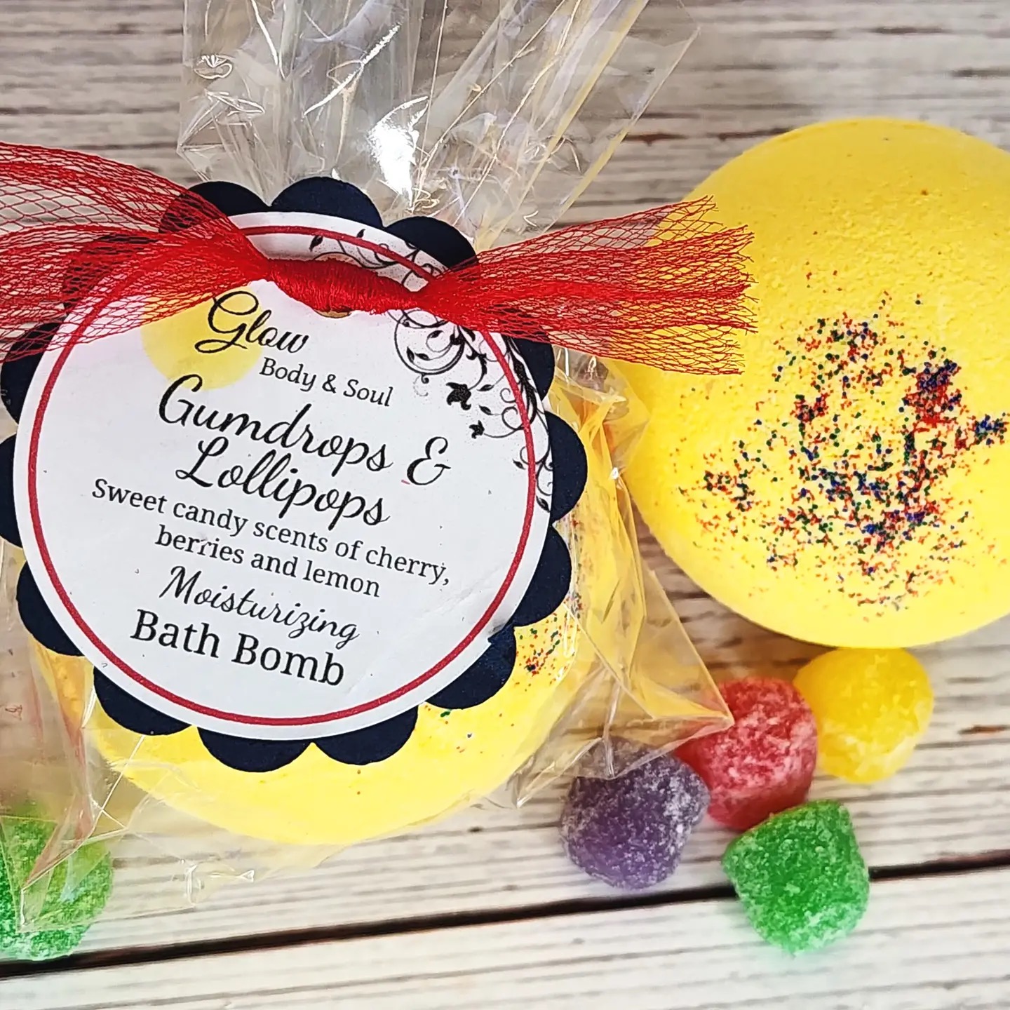 Glow Body & Soul Gumdrops & Lollipops yellow moisturizing bath bomb with candy scents of cherry, berries, and lemon