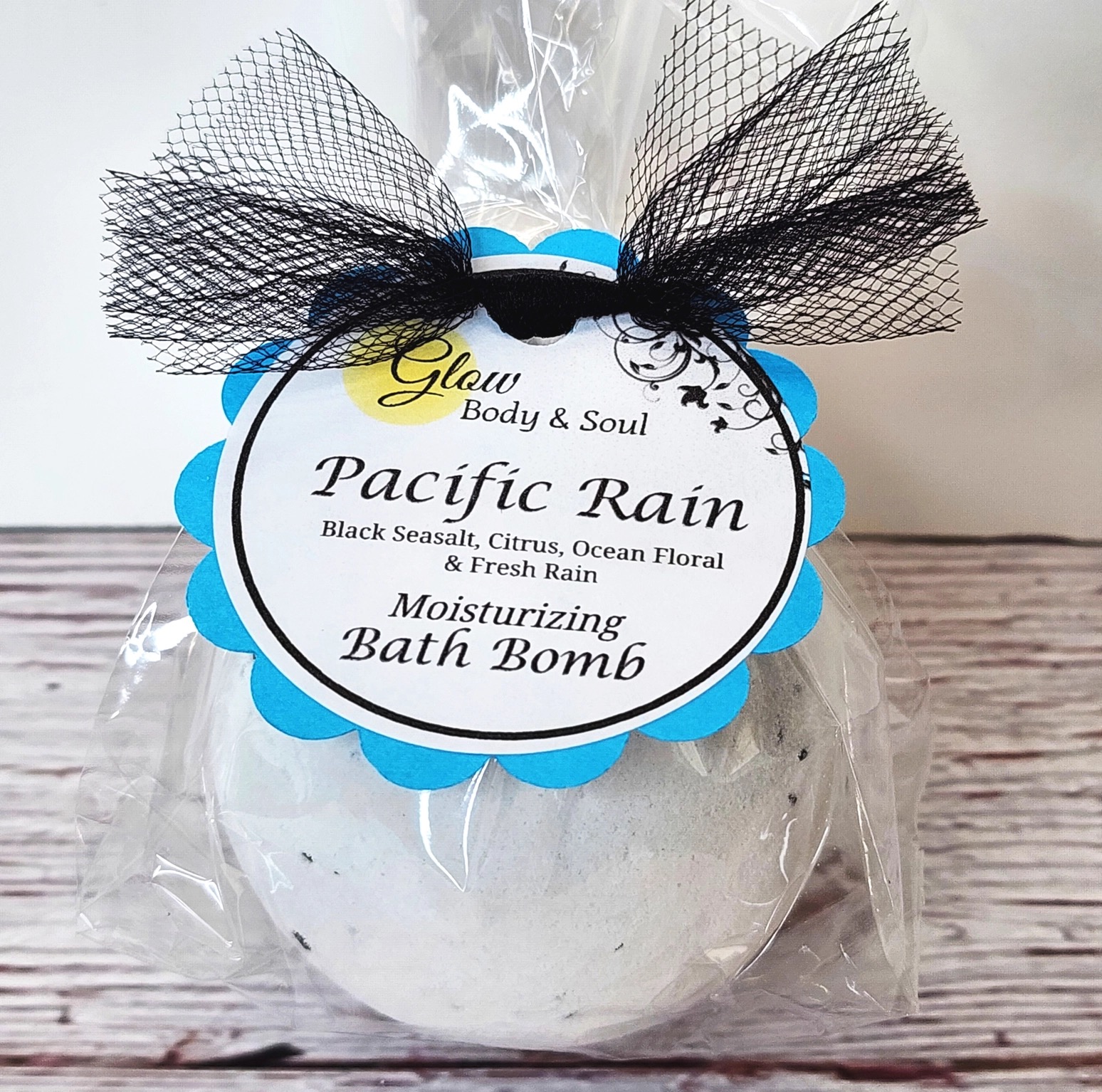 Glow Body & Soul Pacific Rain white moisturizing bath bomb with black seasalt citrus and ocean floral scent