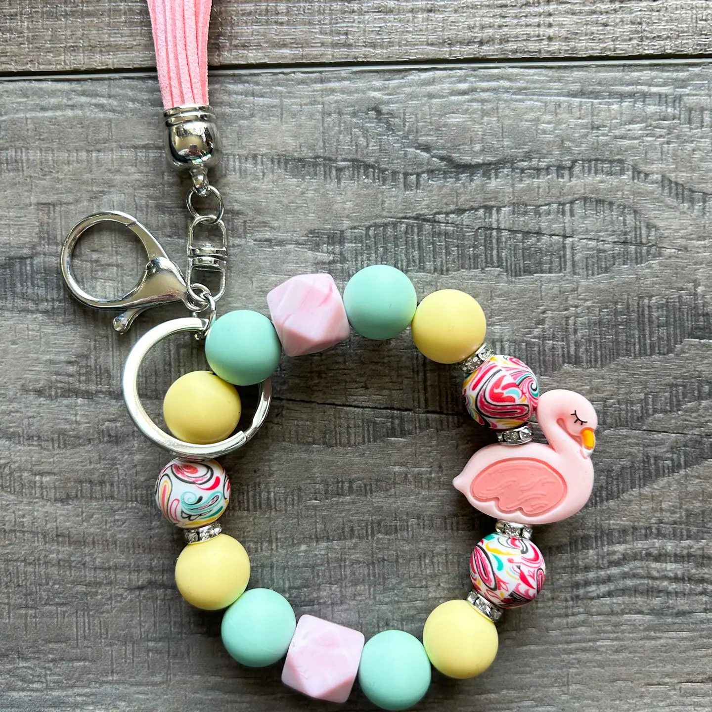 Flamingo silicone bead wristlet keychain in pastel mint, yellow, and pink with pink tassel